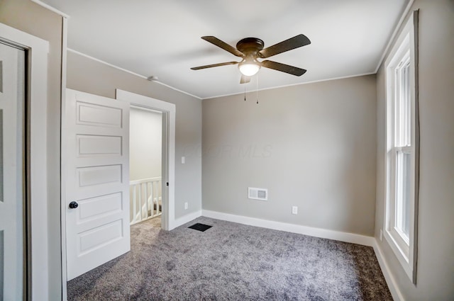 unfurnished bedroom with visible vents, carpet flooring, baseboards, and ceiling fan