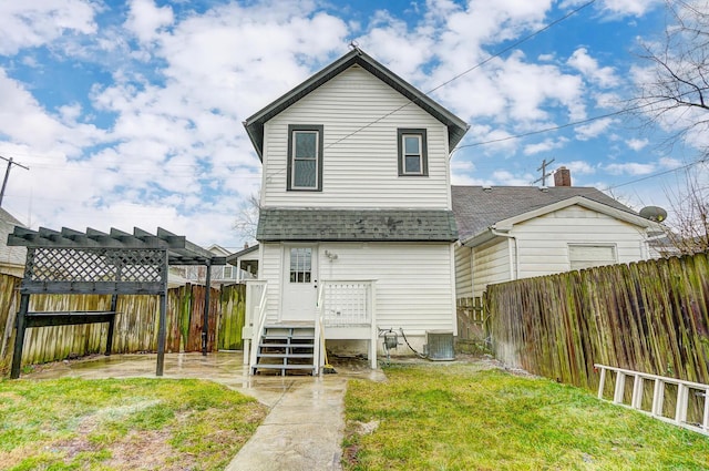 back of house with central AC, roof with shingles, a lawn, a fenced backyard, and a pergola