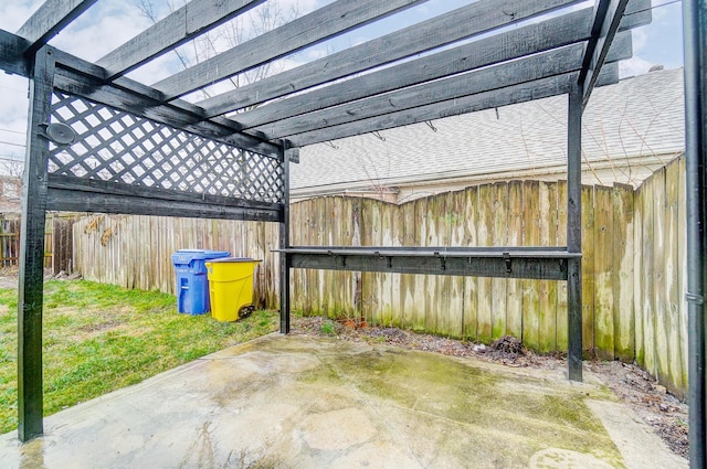 view of patio with a pergola and fence