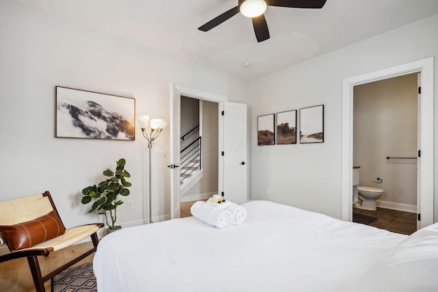 bedroom featuring connected bathroom, a ceiling fan, and baseboards