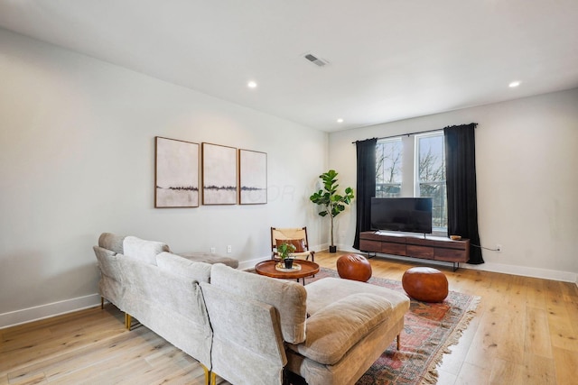 living area with recessed lighting, visible vents, baseboards, and light wood-style floors