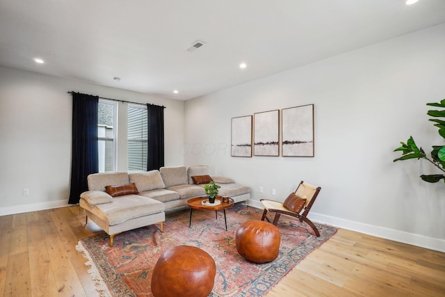 living room featuring visible vents, recessed lighting, baseboards, and wood-type flooring