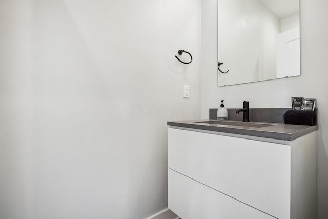 bathroom with baseboards and vanity