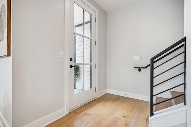 entrance foyer featuring light wood-style floors, baseboards, and a wealth of natural light