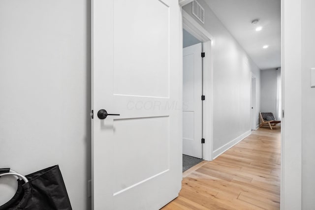 corridor with recessed lighting, visible vents, baseboards, and wood finished floors