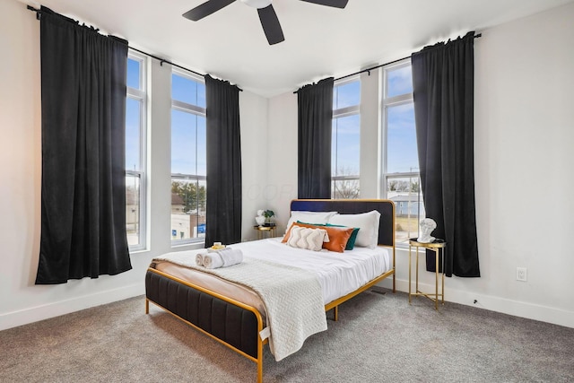 bedroom featuring carpet flooring, baseboards, and expansive windows