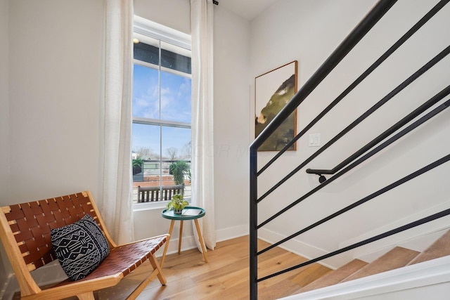 staircase with wood finished floors and baseboards