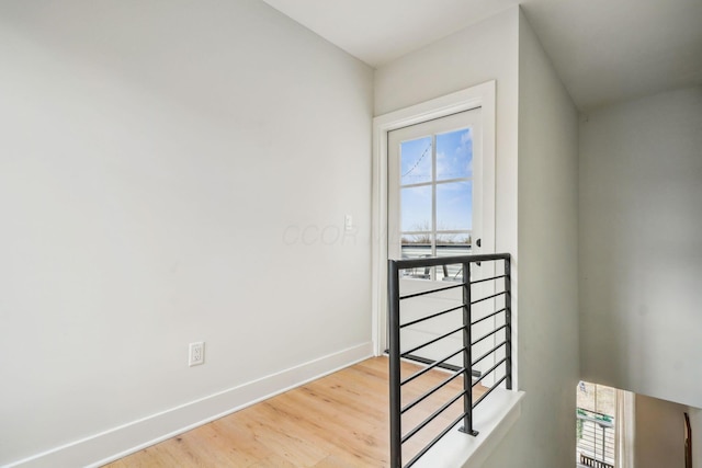 stairway with baseboards and wood finished floors