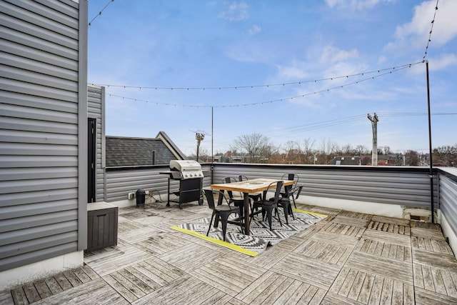 deck featuring area for grilling and outdoor dining area