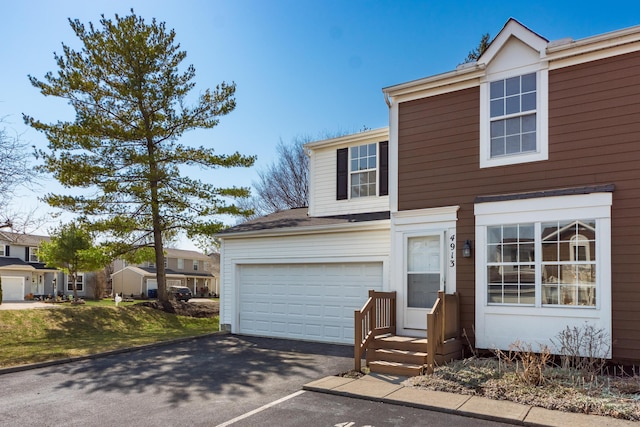 traditional-style house featuring driveway and an attached garage