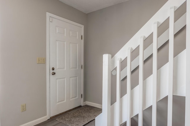 mudroom with baseboards and wood finished floors