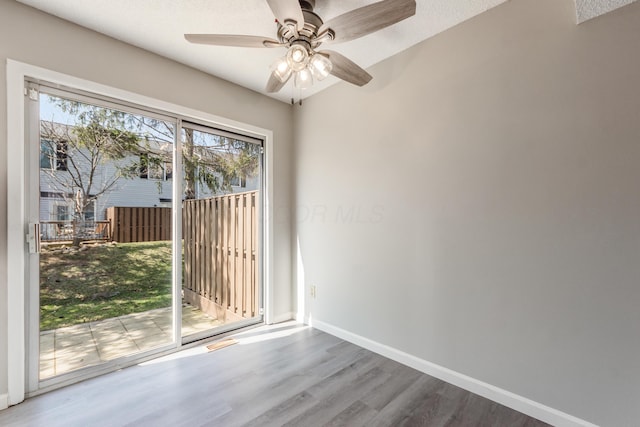 unfurnished room with visible vents, ceiling fan, baseboards, and wood finished floors