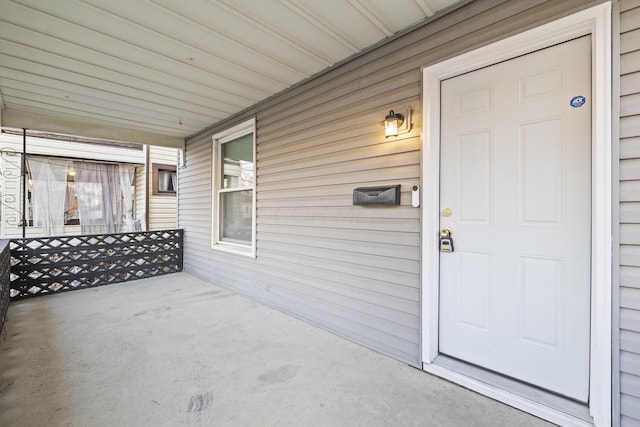 view of exterior entry with a porch