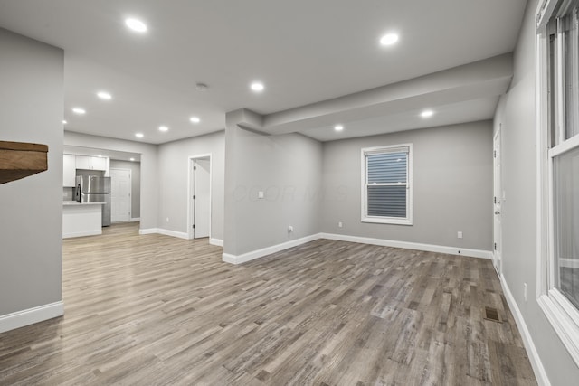 interior space with visible vents, recessed lighting, light wood-type flooring, and baseboards