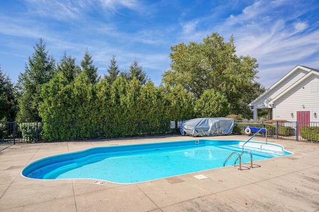 pool with a patio, area for grilling, and fence