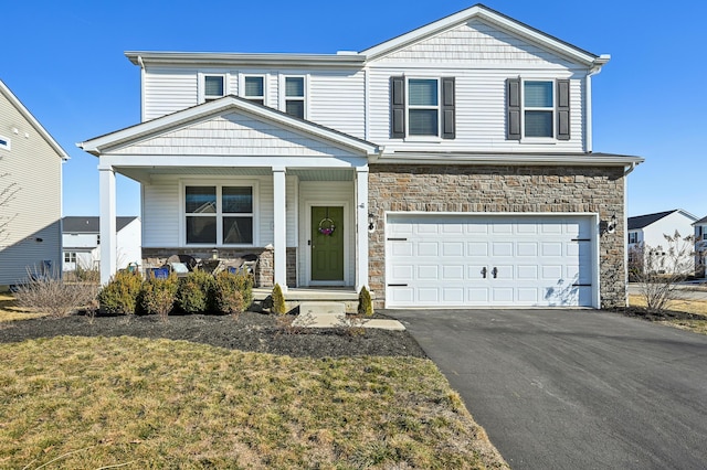 view of front of home with aphalt driveway, stone siding, covered porch, and a garage