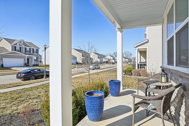 view of patio / terrace with a residential view and covered porch