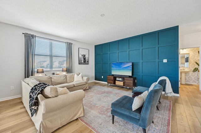 living room with light wood finished floors and baseboards