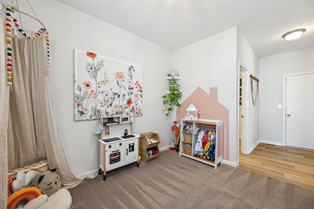 playroom featuring baseboards and carpet floors