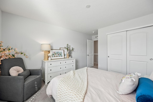 carpeted bedroom with a closet