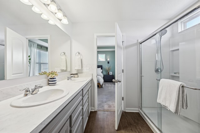 full bathroom with a sink, wood finished floors, and a stall shower