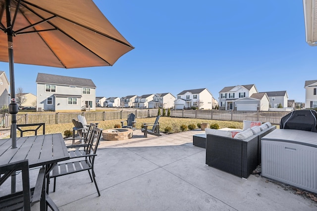 view of patio / terrace with outdoor dining area, a fenced backyard, an outdoor living space with a fire pit, grilling area, and a residential view