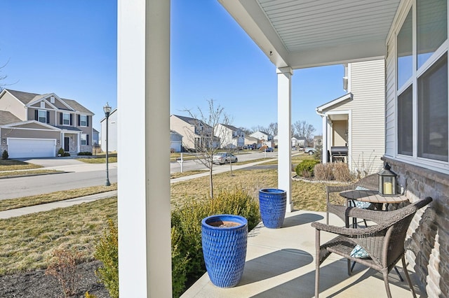 view of patio with covered porch and a residential view