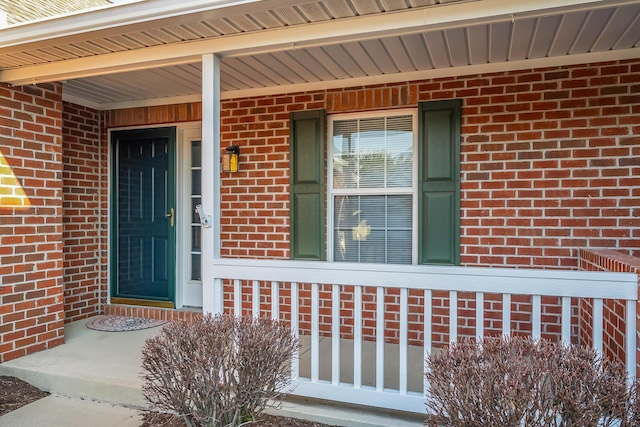 view of exterior entry featuring brick siding