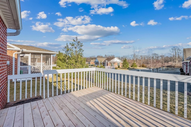 wooden deck with a residential view and a sunroom