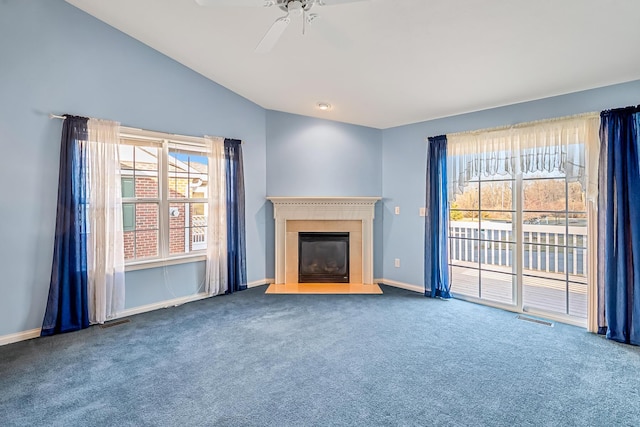 unfurnished living room with visible vents, a healthy amount of sunlight, ceiling fan, carpet, and lofted ceiling