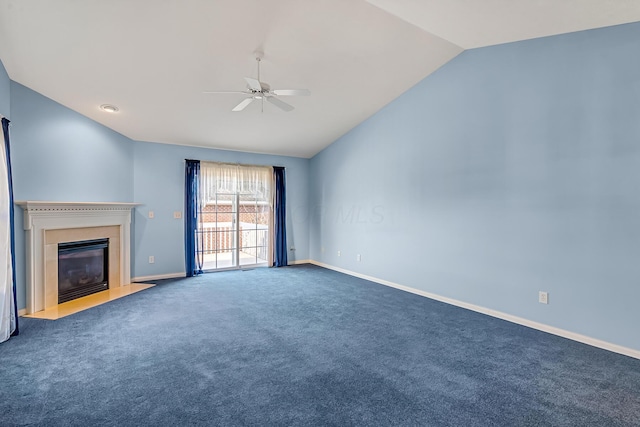 unfurnished living room with baseboards, ceiling fan, a fireplace with flush hearth, carpet floors, and vaulted ceiling