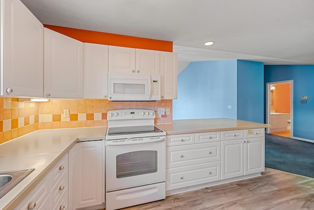 kitchen with white appliances, backsplash, light countertops, and white cabinetry