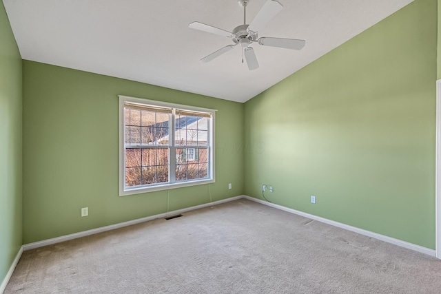 unfurnished room featuring baseboards, lofted ceiling, carpet, and a ceiling fan