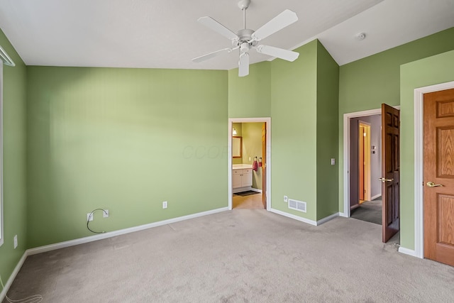 unfurnished bedroom featuring ensuite bath, visible vents, baseboards, and carpet