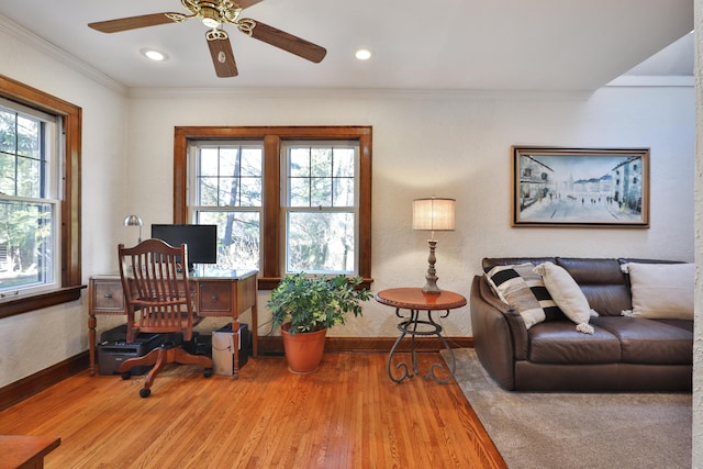 office area featuring a ceiling fan, wood finished floors, baseboards, and ornamental molding