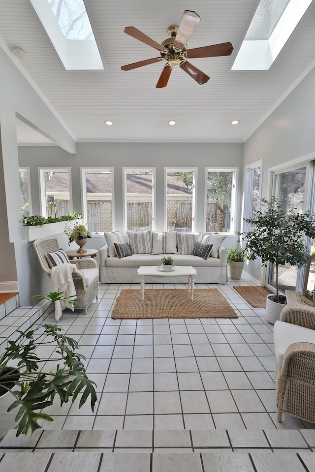 living area featuring light tile patterned floors, recessed lighting, a skylight, and ornamental molding