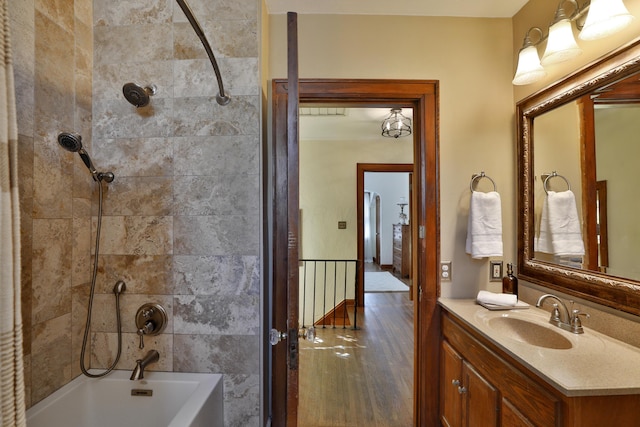 full bath with vanity, bathtub / shower combination, and wood finished floors