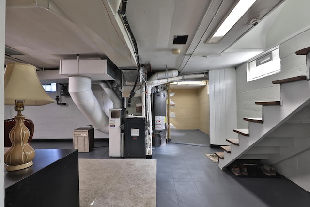 basement with water heater, heating unit, and stairs