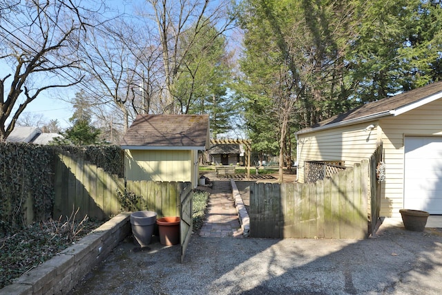 view of yard featuring an outdoor structure and fence