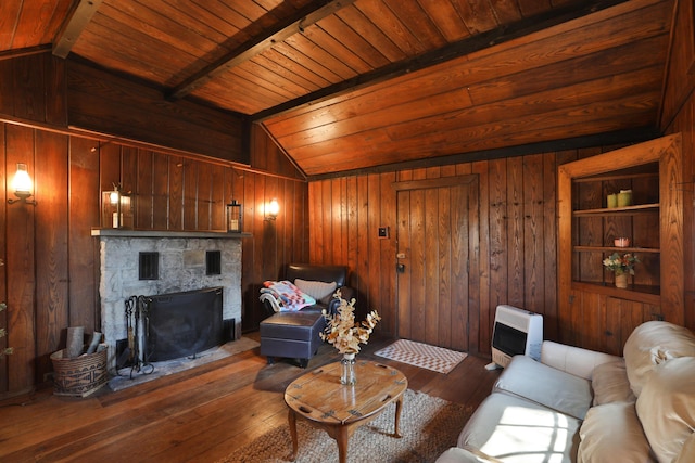 living room featuring lofted ceiling with beams, wooden walls, heating unit, and dark wood-style flooring