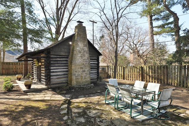 view of outdoor structure with an outbuilding and a fenced backyard