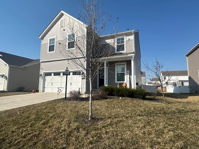 view of front of property with concrete driveway, an attached garage, board and batten siding, and a front yard