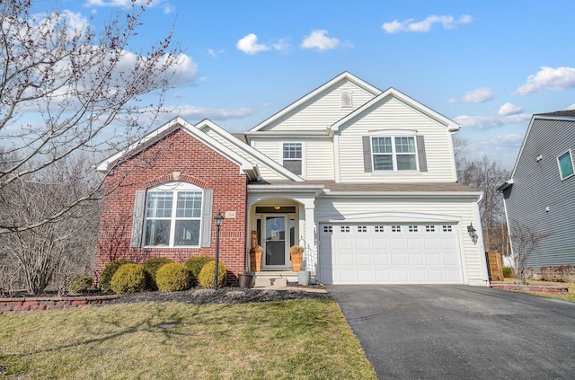 traditional home with aphalt driveway, an attached garage, brick siding, and a front lawn