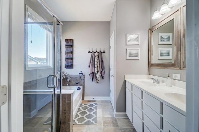 full bath featuring baseboards, double vanity, a stall shower, a sink, and a garden tub