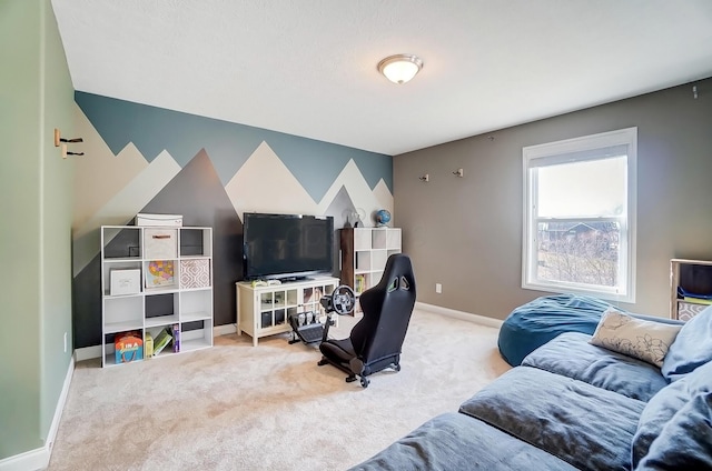 carpeted living area featuring an accent wall and baseboards