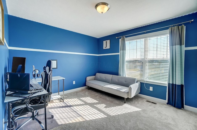 carpeted home office featuring baseboards and visible vents