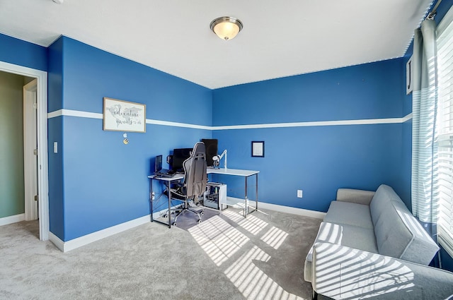 carpeted office space featuring baseboards