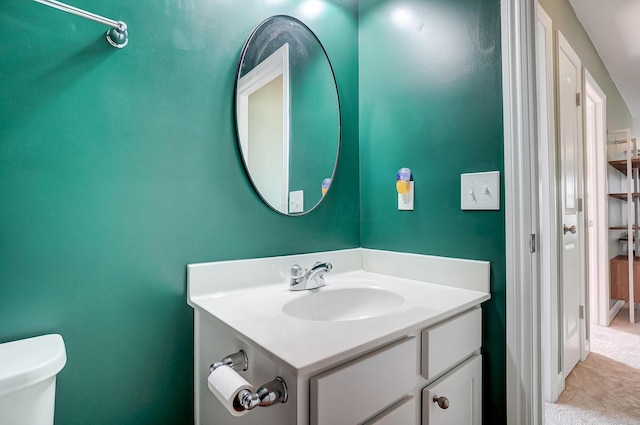 half bathroom featuring toilet and vanity