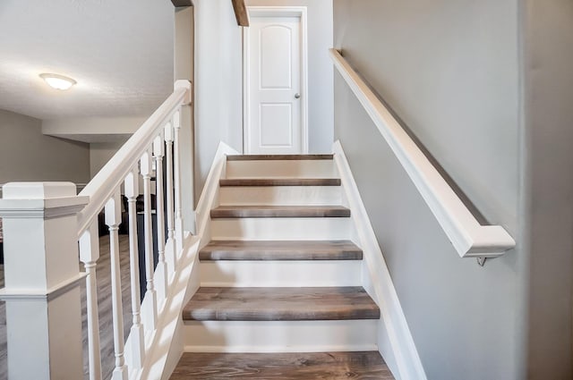 stairway with wood finished floors