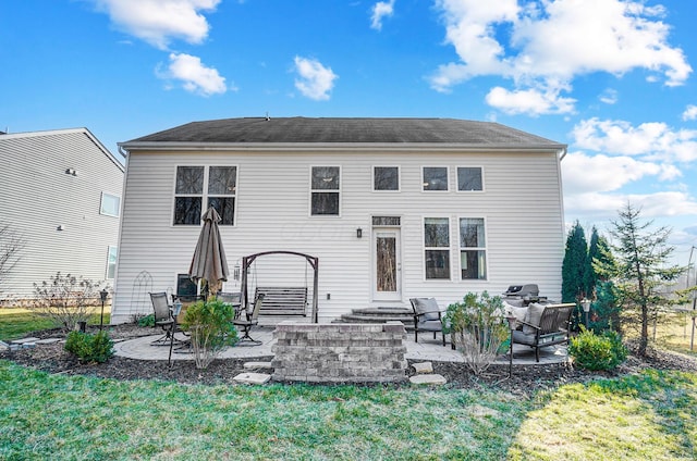 back of house featuring a patio area and a lawn